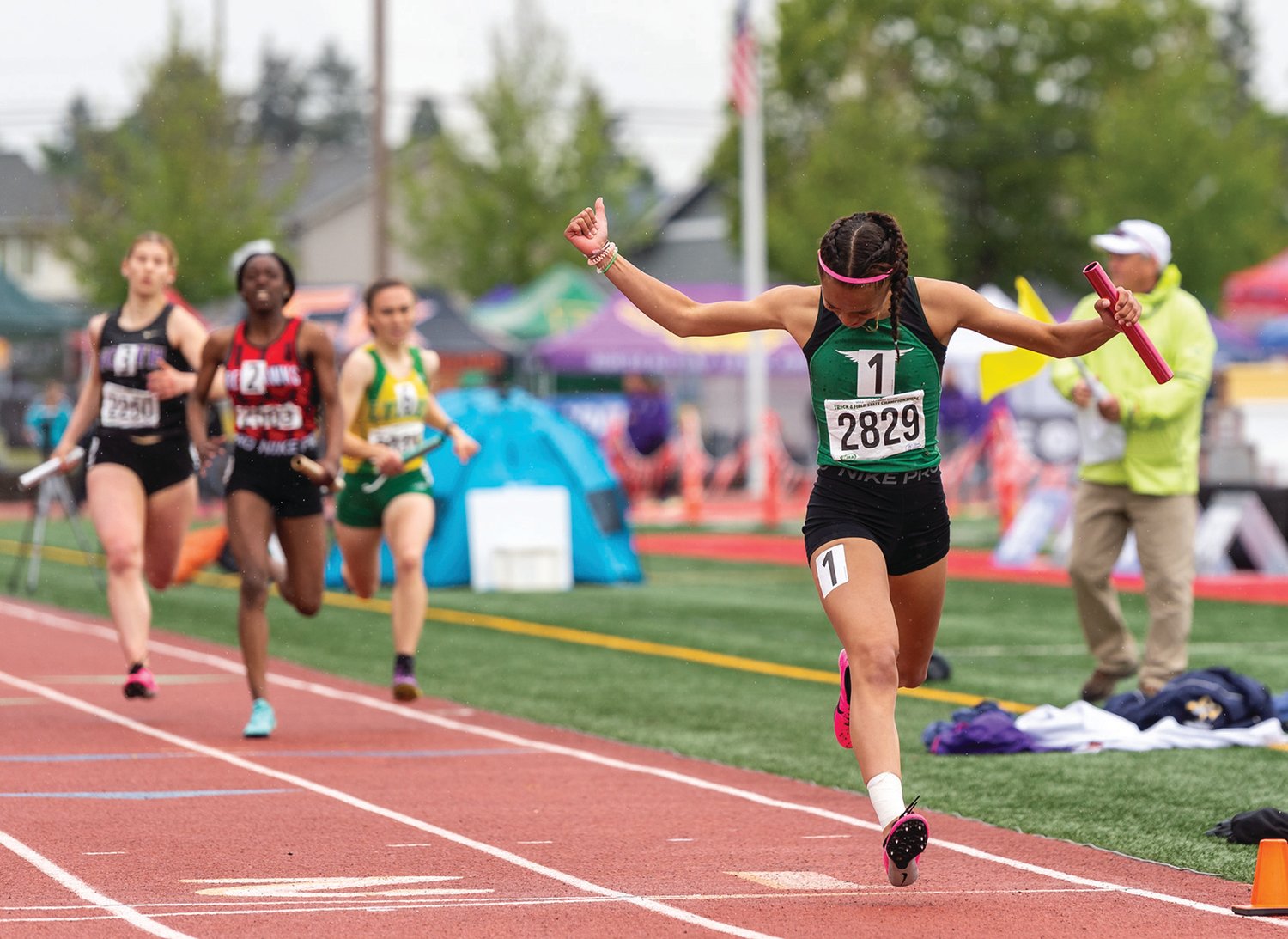 Tumwater's Ava Jones celebrates as she crosses the finish line as the anchor leg of the T-Birds' champion 2A Girls 4x200 relay team at the 4A/3A/2A State Track and Field Championships on Saturday, May 28, 2022, at Mount Tahoma High School in Tacoma. (Joshua Hart/For The Chronicle)